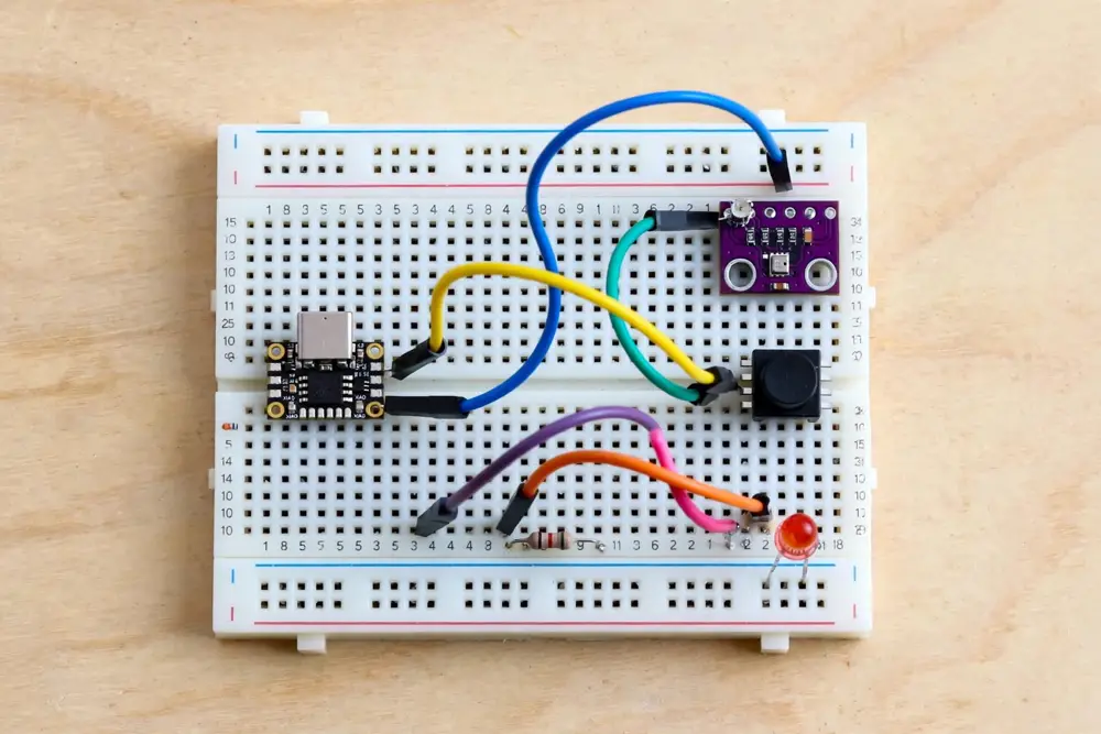 The breadboard prototype: XIAO, microphone module, trigger button, and LED with resistor. Illustration - wire from the table on the next page, not this picture.